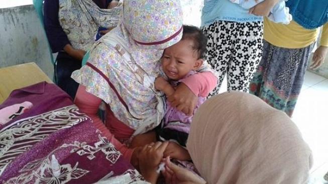 Illustration: A child attending the integrated health post, or Posyandu, in Masawah village in West Java. (Photo: Masawah Village Government)